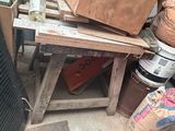 a pile of junk sitting on the ground next to a trash can