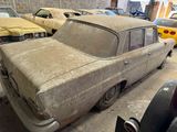 many old cars that are parked in a garage