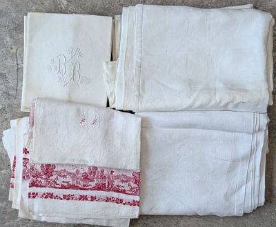 several white towels with red and white designs on them sitting on a table