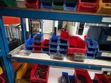 many plastic bins on the shelves in the store