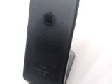 a black iphone sitting on a stand on a white surface