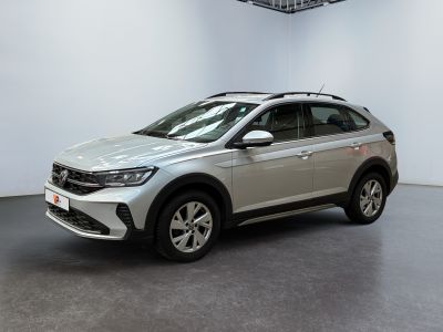 a silver volkswagen suv parked in a large room