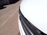 a white car parked on the side of the road