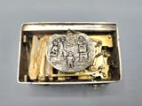 an image of a silver buckle with a coin inside of it