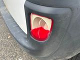 a close up of a car ' s rear end with a red light