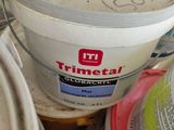 a bucket of paint sitting on top of a pile of buckets
