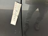 a man standing next to a refrigerator with a ruler on it