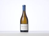 a bottle of white wine sitting on top of a table