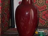 a lamp that is sitting on a table next to a curtain