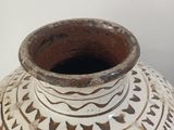 a white vase with a black and white design on it