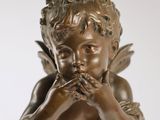 an image of a statue of a little boy with a flower in his hand