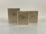 three chanel perfume bottles on a white surface
