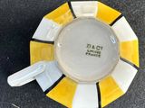 a yellow and white plate with a black and white stripe around it