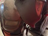 a motorcycle that has a helmet on the back of it