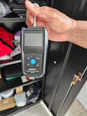 a man holding a digital thermometer in his hand