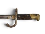 a close up of a knife with a wooden handle on a white surface