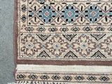 a close up of a rug on the ground with a cat laying on top of it