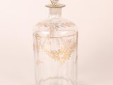 an image of a clear glass bottle with a gold design on it