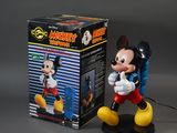 mickey mouse figurine with box on grey background
