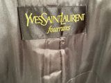 the back of a black and blue jacket with a yellow logo on it