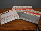 three business cards sitting on top of a table on top of a wooden table