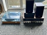 two speakers and a record player sitting on the floor