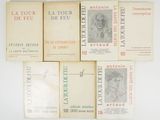 six books on a white surface with a drawing of a woman