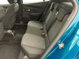 the back seats of a blue car in a car showroom