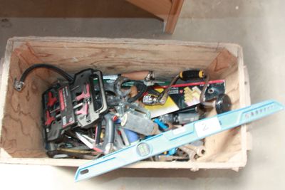 a wooden box filled with tools and a pair of scissors