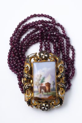 an image of a necklace with a picture of a church on it