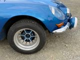 an image of a blue sports car parked in a parking lot