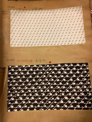 two pieces of fabric on a piece of brown paper