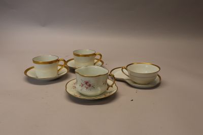 five cups and saucers sitting on a table