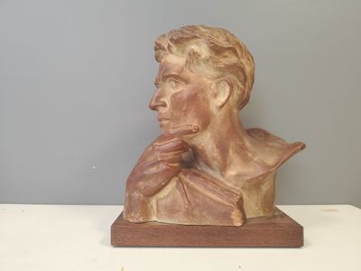 a statue of a man with his hand on his chin