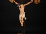 a statue of jesus on the cross on a black background