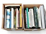 two boxes of books sitting on a white surface
