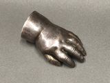 a metal hand that is sitting on a table