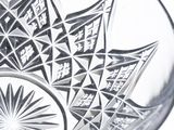 a glass bowl with a design on it on a table