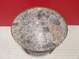 a marble table with a metal base on a tile floor