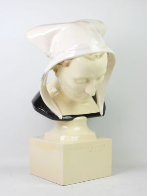 marble bust of a woman wearing a white hat on a marble base