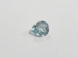 a close up of a blue diamond on a white surface