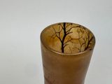 a glass with a tree design on it on a table