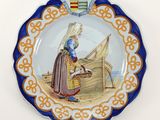 a plate with a picture of a woman sitting on a boat