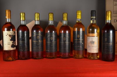 several bottles of wine are lined up on a table