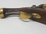 an image of a wooden and brass cased rifle with brass fittings