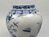a blue and white vase sitting on a table
