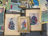 pictures of asian women hanging on a wall in a room