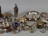 a pile of silver objects on a white surface