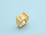 a close up of a gold ring on a blue surface