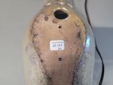 a vase with a tag on it sitting on a table